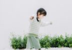 girl walking with arms outstretched