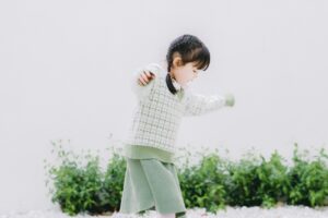 girl walking with arms outstretched